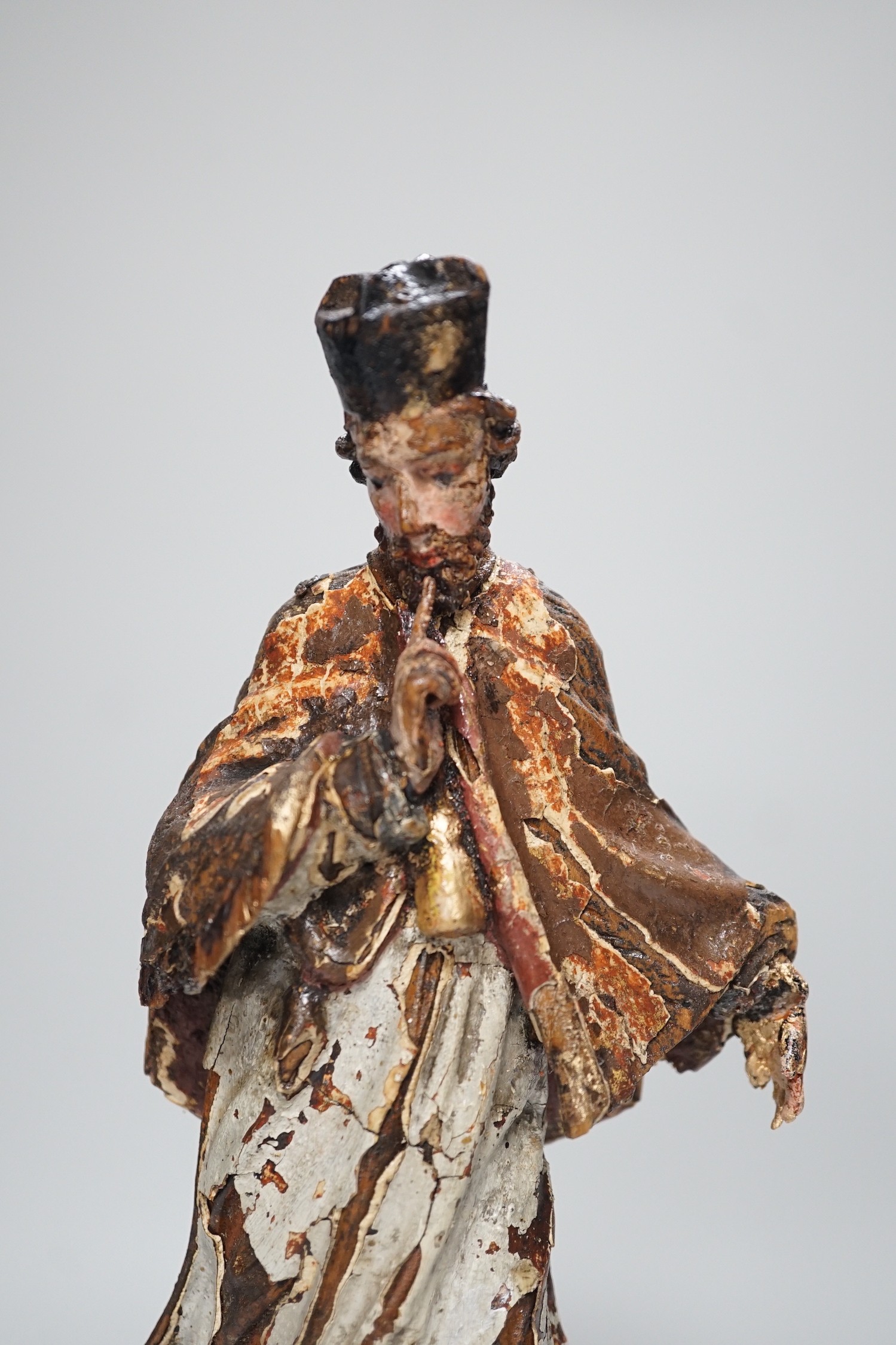 An 18th/19th century Continental carved wooden polychrome figure of saint, 33cms high